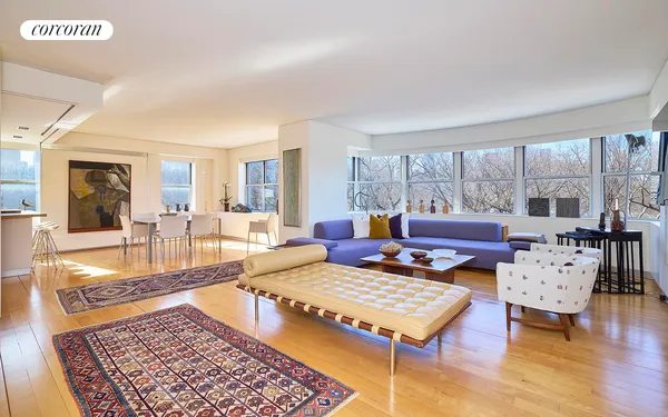 a living room with furniture a rug and a table