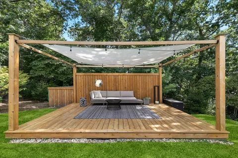 a view of a backyard with sitting area