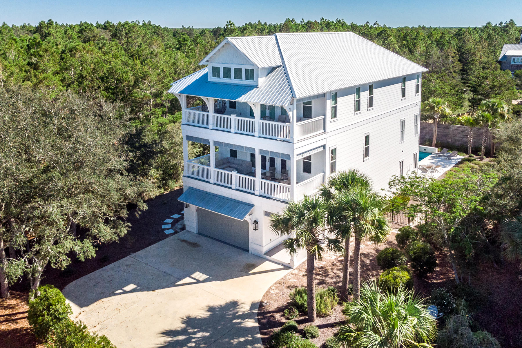 150 Walton Gulfview Dr Inlet Beach Inlet Beach, FL 32461 - Photo 1 of 61 a view of a white house with a yard and potted plants