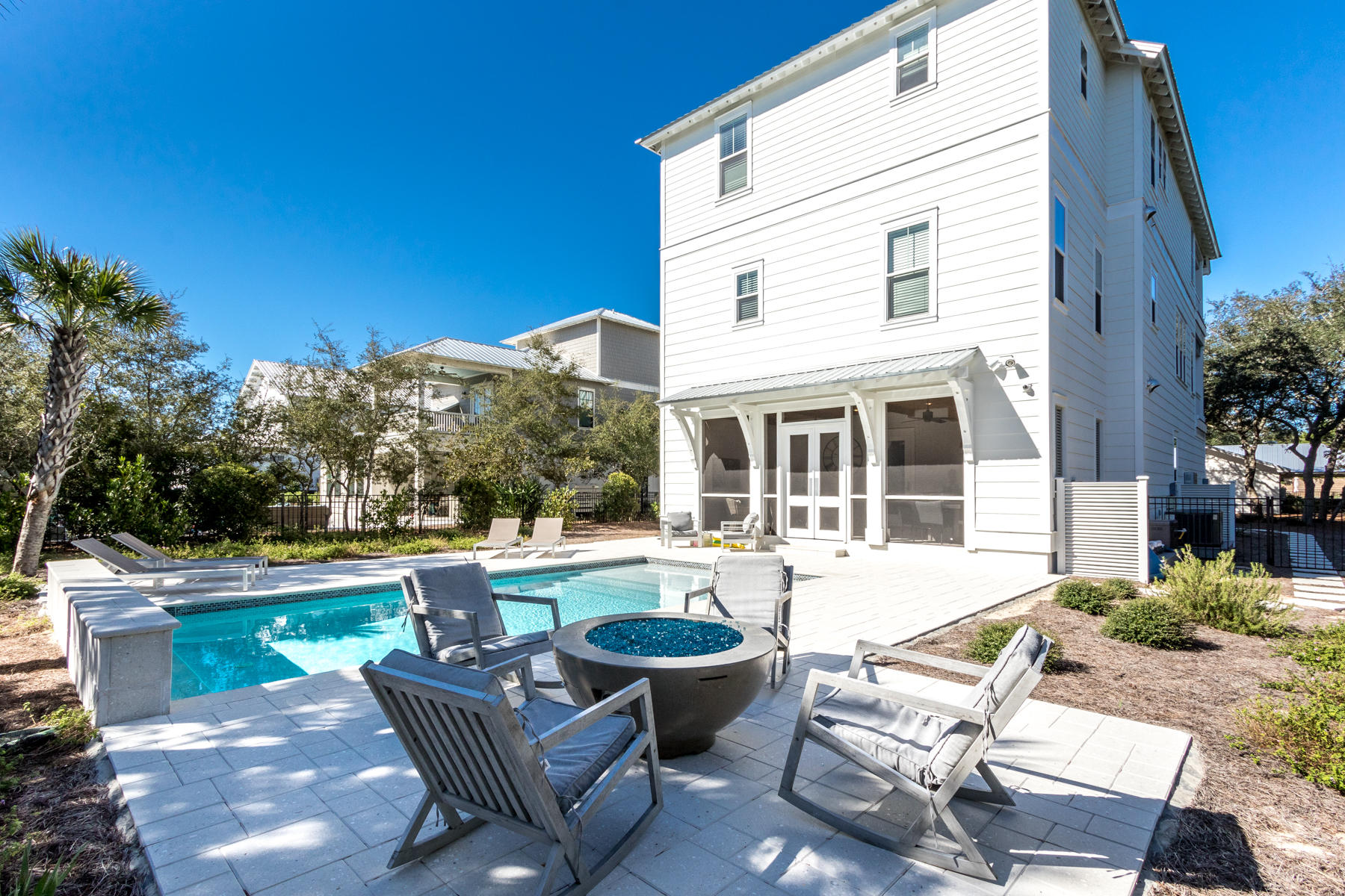 150 Walton Gulfview Dr Inlet Beach Inlet Beach, FL 32461 - Photo 11 of 61 a view of a patio with couches table and chairs under an umbrella