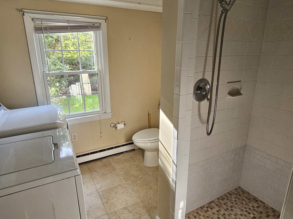 135 Walker Pond Road Sturbridge, MA 01566 - Photo 3 of 16 a bathroom with a granite countertop toilet a sink and a shower