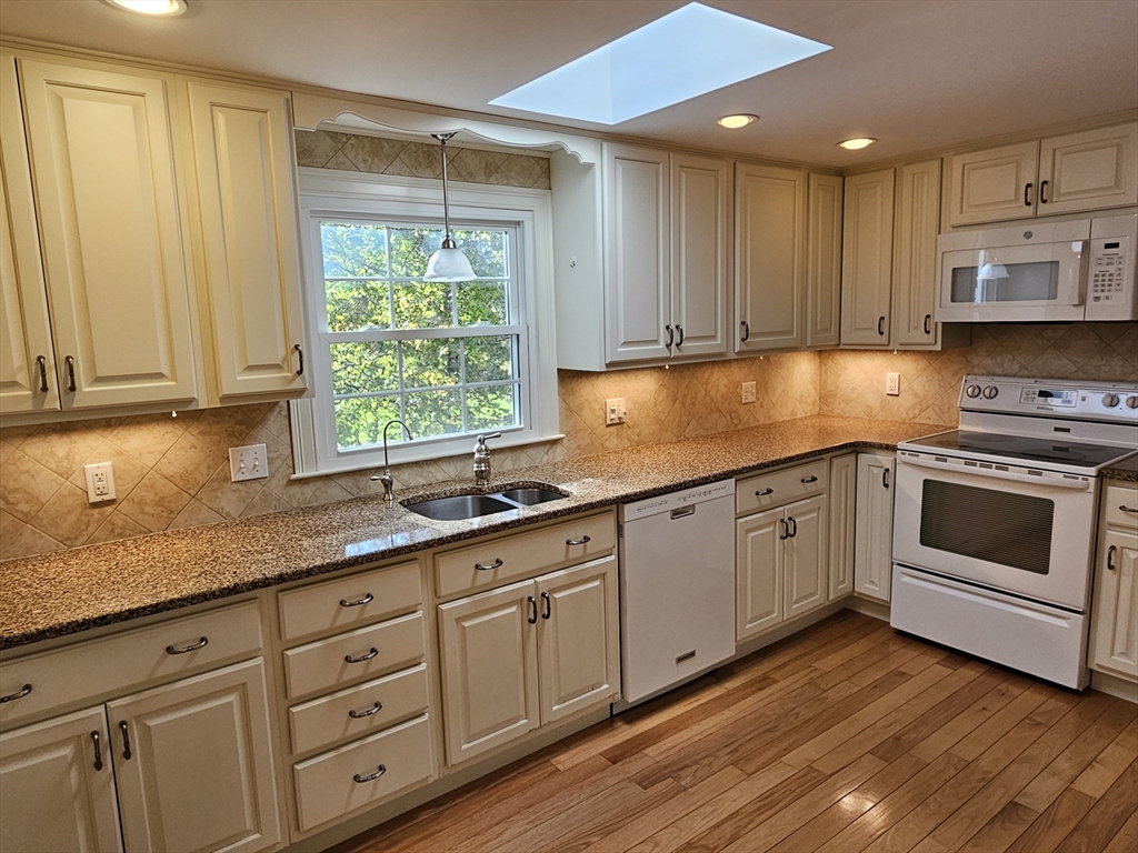 135 Walker Pond Road Sturbridge, MA 01566 - Photo 4 of 16 a kitchen with granite countertop stainless steel appliances white cabinets granite counter tops and a window