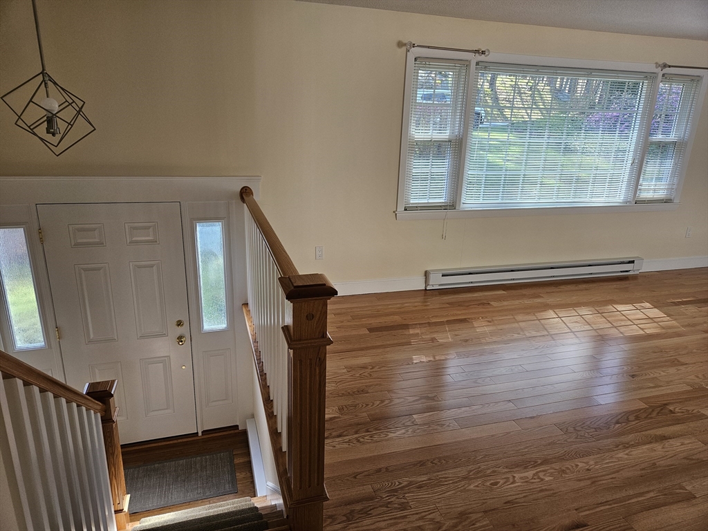 135 Walker Pond Road Sturbridge, MA 01566 - Photo 8 of 16 a view of empty room with wooden floor and fan