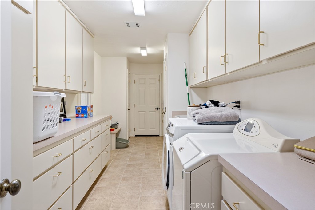4342 Shadow Canyon Road Templeton, CA 93465 - Photo 61 of 72 A large laundry room with incredible storage options and counter space, providing the perfect setup for efficiency and organization.