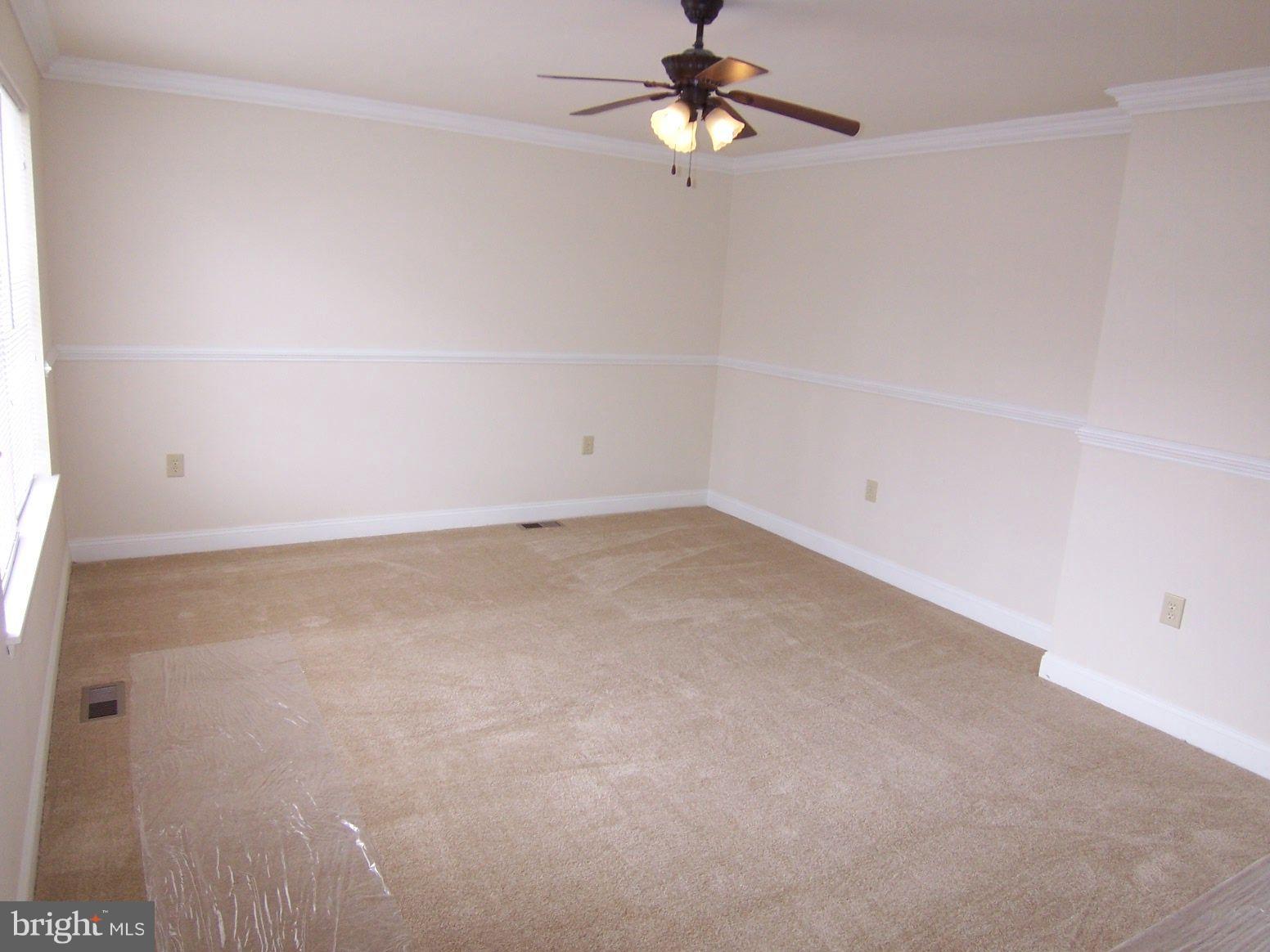 309 Laburnum Road Edgewood, MD 21040 - Photo 17 of 19 an empty room with a chandelier fan and windows
