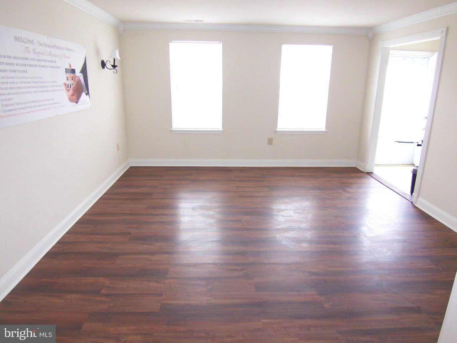 309 Laburnum Road Edgewood, MD 21040 - Photo 4 of 19 a view of an empty room with wooden floor and a window