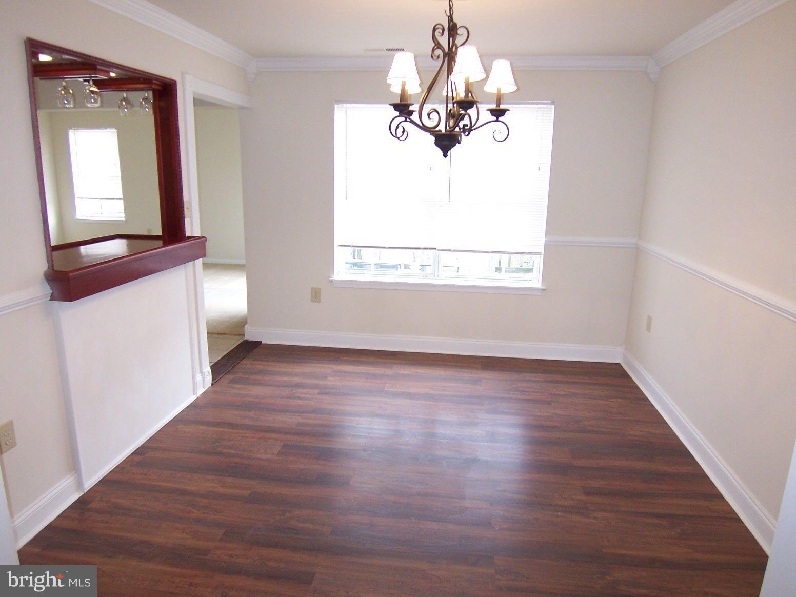 309 Laburnum Road Edgewood, MD 21040 - Photo 5 of 19 wooden floor in an empty room with a window