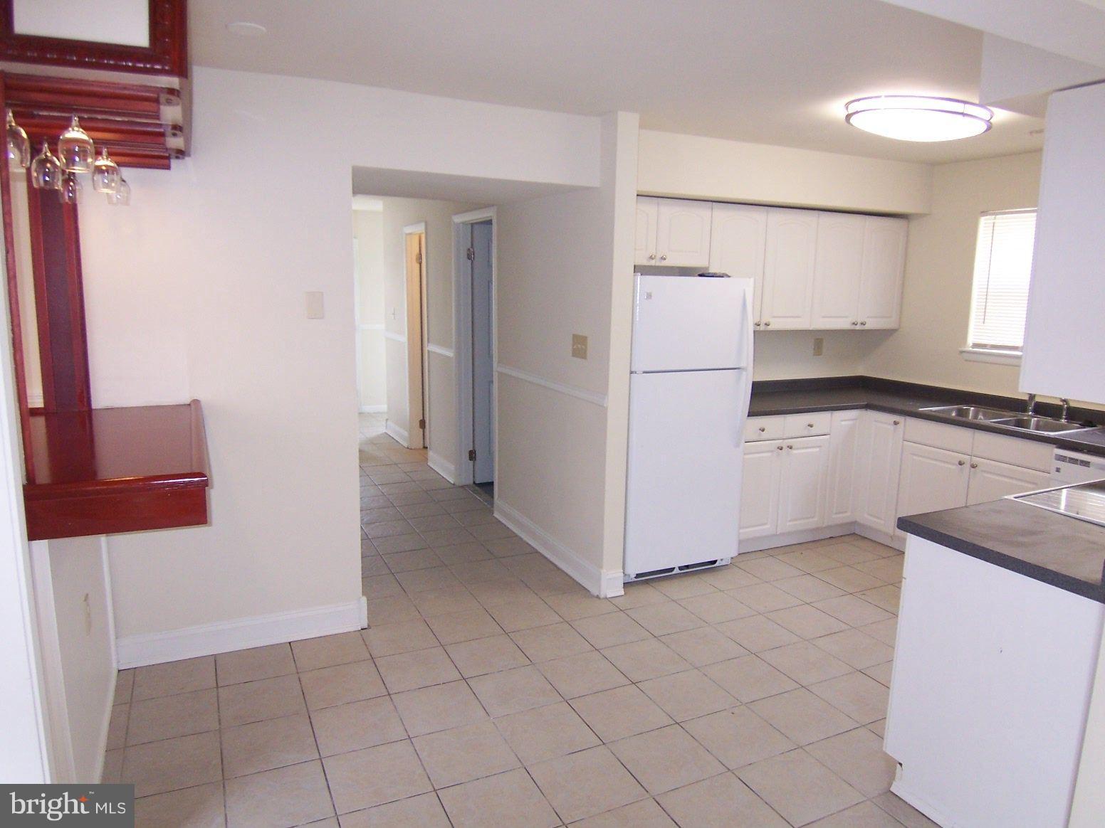 309 Laburnum Road Edgewood, MD 21040 - Photo 10 of 19 a kitchen with granite countertop white cabinets and white appliances