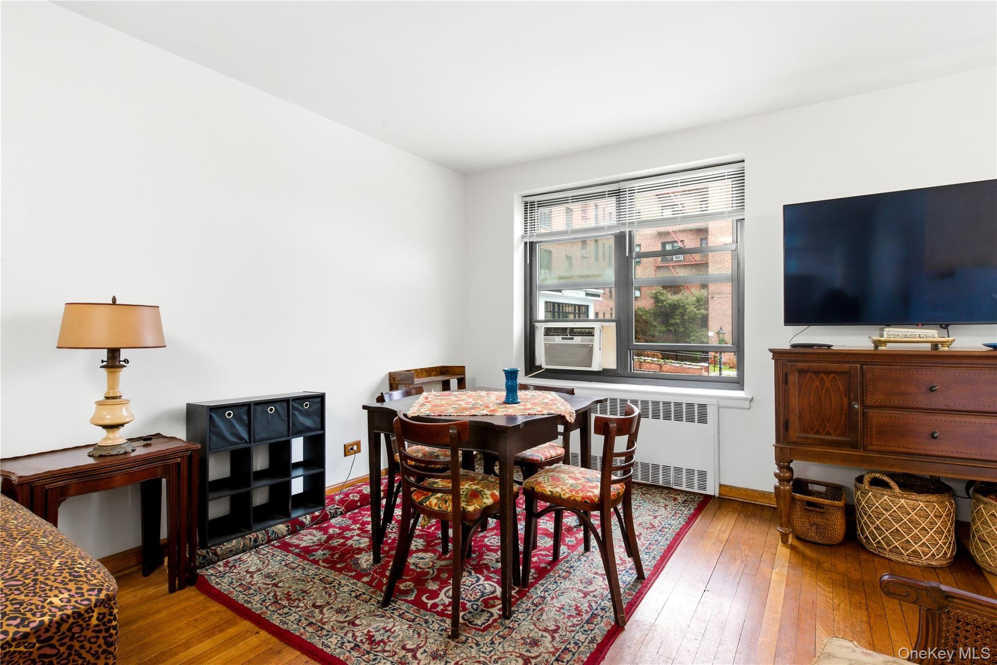 100-11 67th Road, Unit 107 Queens, NY 11375 - Photo 14 of 24 a livingroom with furniture and a flat screen tv