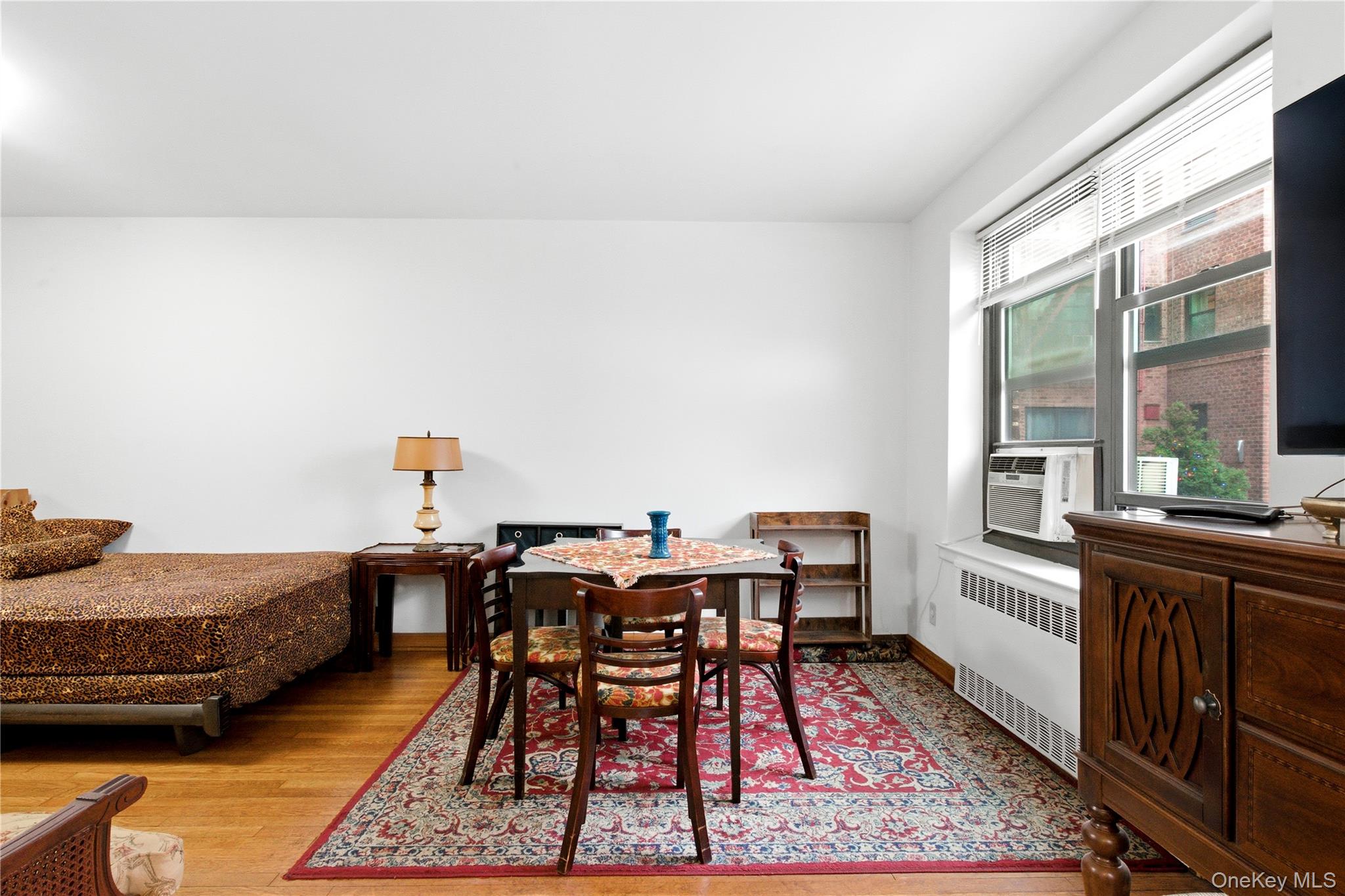 100-11 67th Road, Unit 107 Queens, NY 11375 - Photo 15 of 24 a view of a dining room with furniture and window