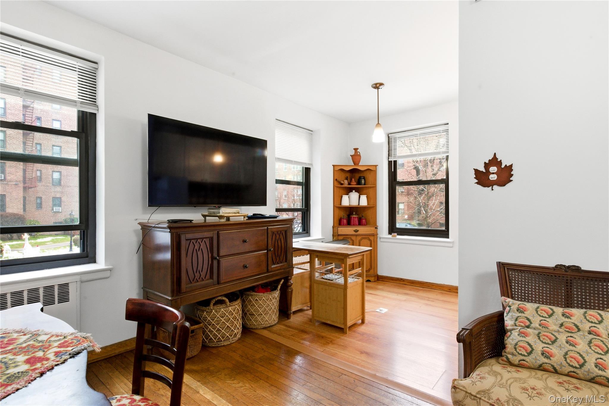 100-11 67th Road, Unit 107 Queens, NY 11375 - Photo 16 of 24 a living room with furniture and a flat screen tv