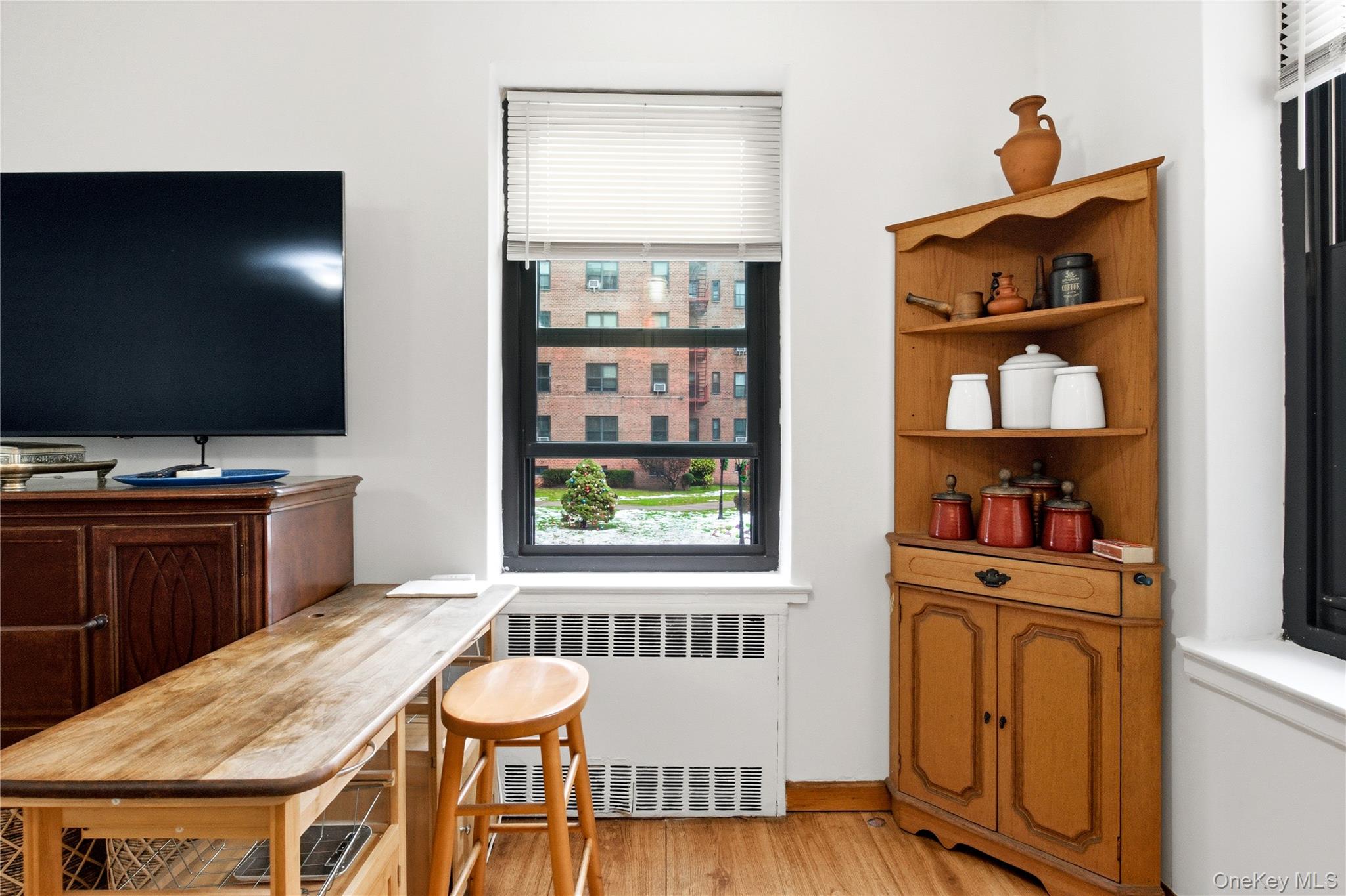 100-11 67th Road, Unit 107 Queens, NY 11375 - Photo 20 of 24 a kitchen with stainless steel appliances granite countertop a stove and a microwave with wooden floor