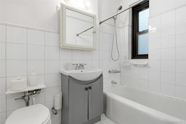 a bathroom with a sink a toilet and bathtub