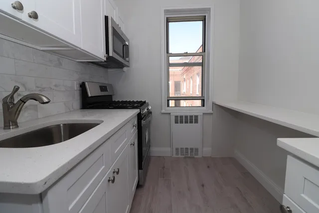 a kitchen with stainless steel appliances a sink and cabinets