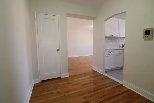 a view of a hallway with wooden floor