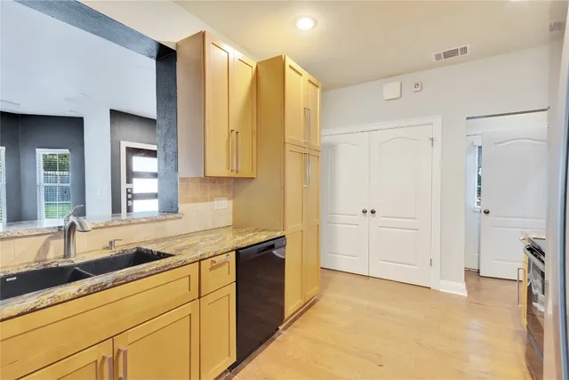 a kitchen with a sink and a refrigerator