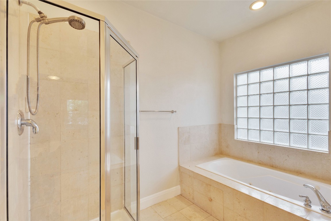 2358 Wilson Street Austin, TX 78704 - Photo 16 of 33 a bathroom with a bathtub and a shower