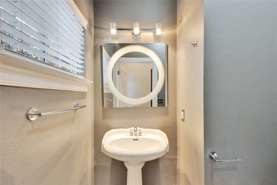 2358 Wilson Street Austin, TX 78704 - Photo 26 of 33 a bathroom with a sink and a mirror