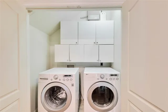 a view of storage and utility room with washer and dryer