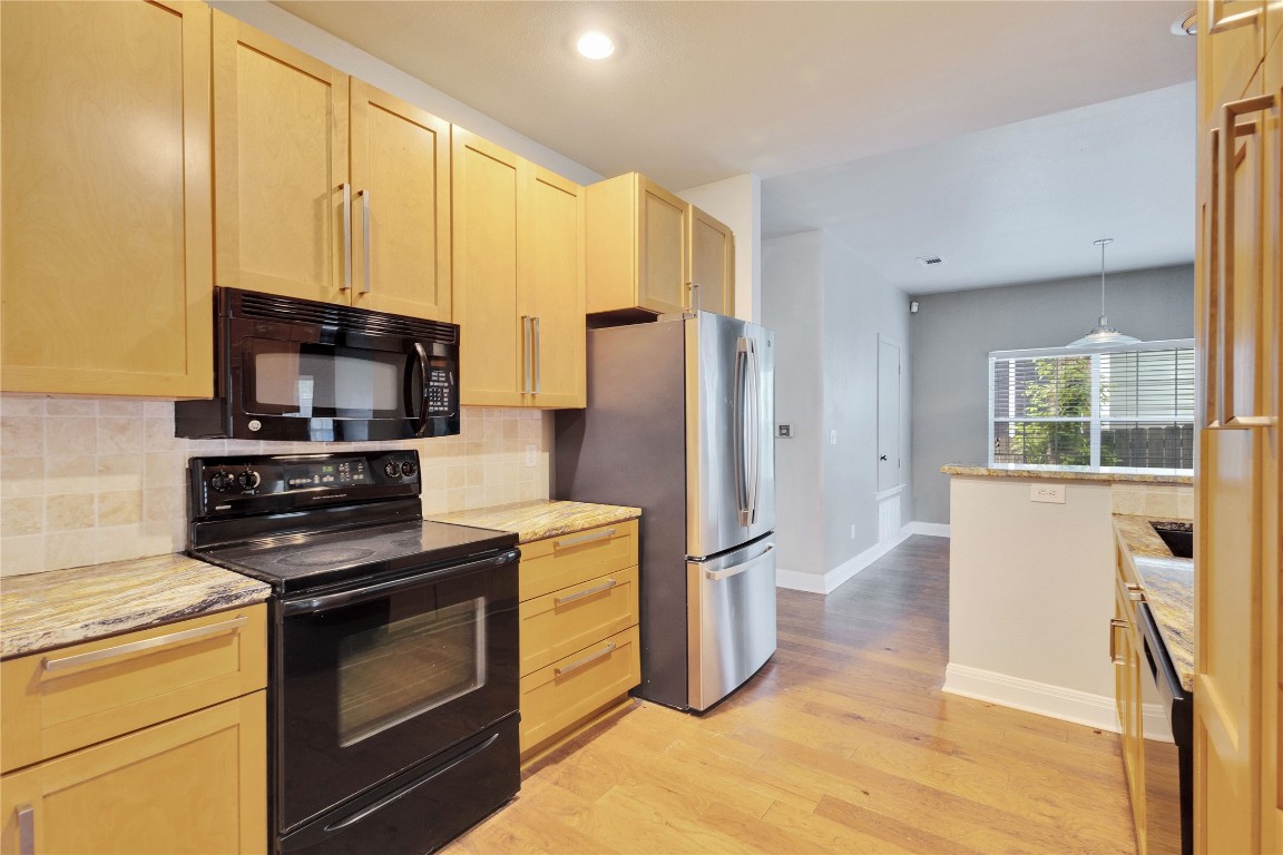 2358 Wilson Street Austin, TX 78704 - Photo 10 of 33 a kitchen with stainless steel appliances granite countertop a refrigerator stove and sink