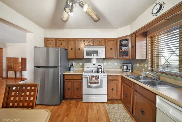 a kitchen with stainless steel appliances granite countertop a refrigerator sink and stove