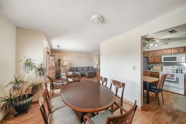 a dining room with furniture and wooden floor