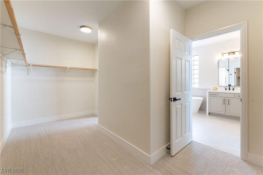 9632 Staff Lane Las Vegas, NV 89178 - Photo 17 of 53 Hall with light colored carpet and baseboards