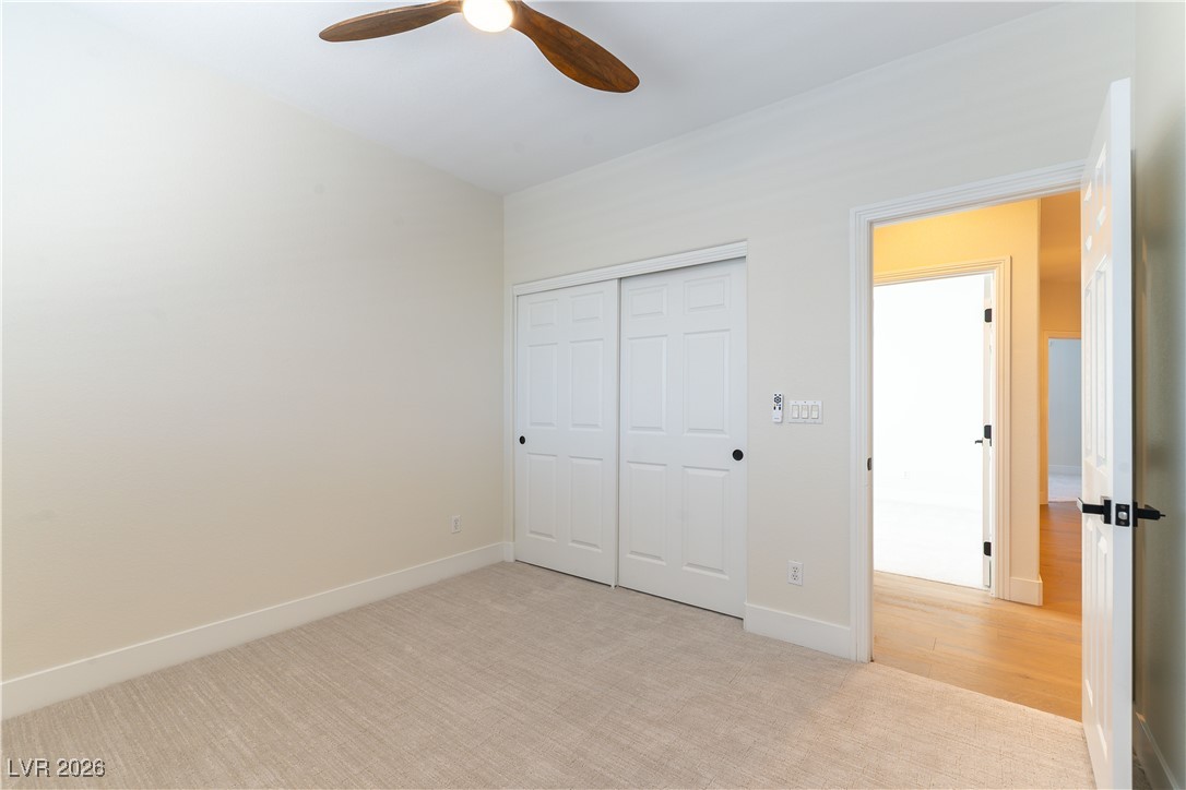 9632 Staff Lane Las Vegas, NV 89178 - Photo 19 of 53 Unfurnished bedroom featuring light carpet, a closet, and ceiling fan