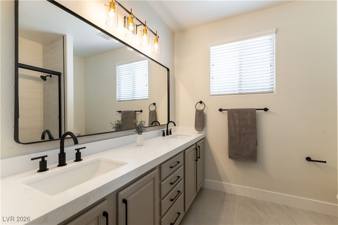 9632 Staff Lane Las Vegas, NV 89178 - Photo 20 of 53 Bathroom featuring double vanity and a shower with door