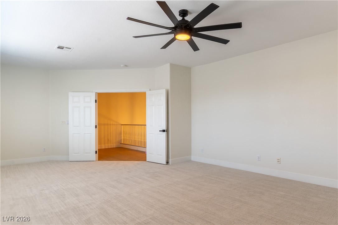 9632 Staff Lane Las Vegas, NV 89178 - Photo 24 of 53 Unfurnished room featuring light colored carpet and a ceiling fan