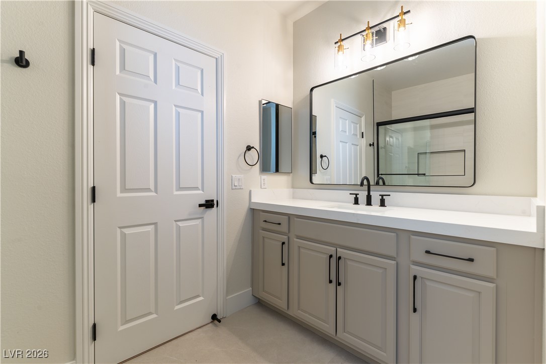 9632 Staff Lane Las Vegas, NV 89178 - Photo 25 of 53 Full bath with vanity, a shower with shower door, and light tile patterned floors