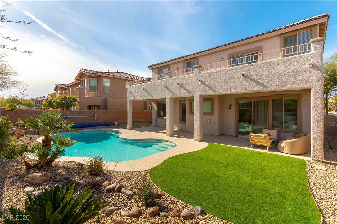 9632 Staff Lane Las Vegas, NV 89178 - Photo 36 of 53 Back of property featuring a patio, stucco siding, a fenced backyard, and a balcony