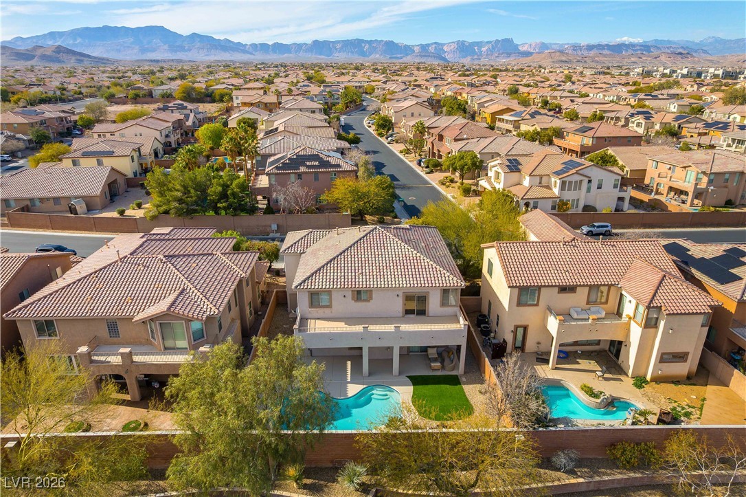 9632 Staff Lane Las Vegas, NV 89178 - Photo 41 of 53 Aerial view of residential area with a mountainous background and a pool area