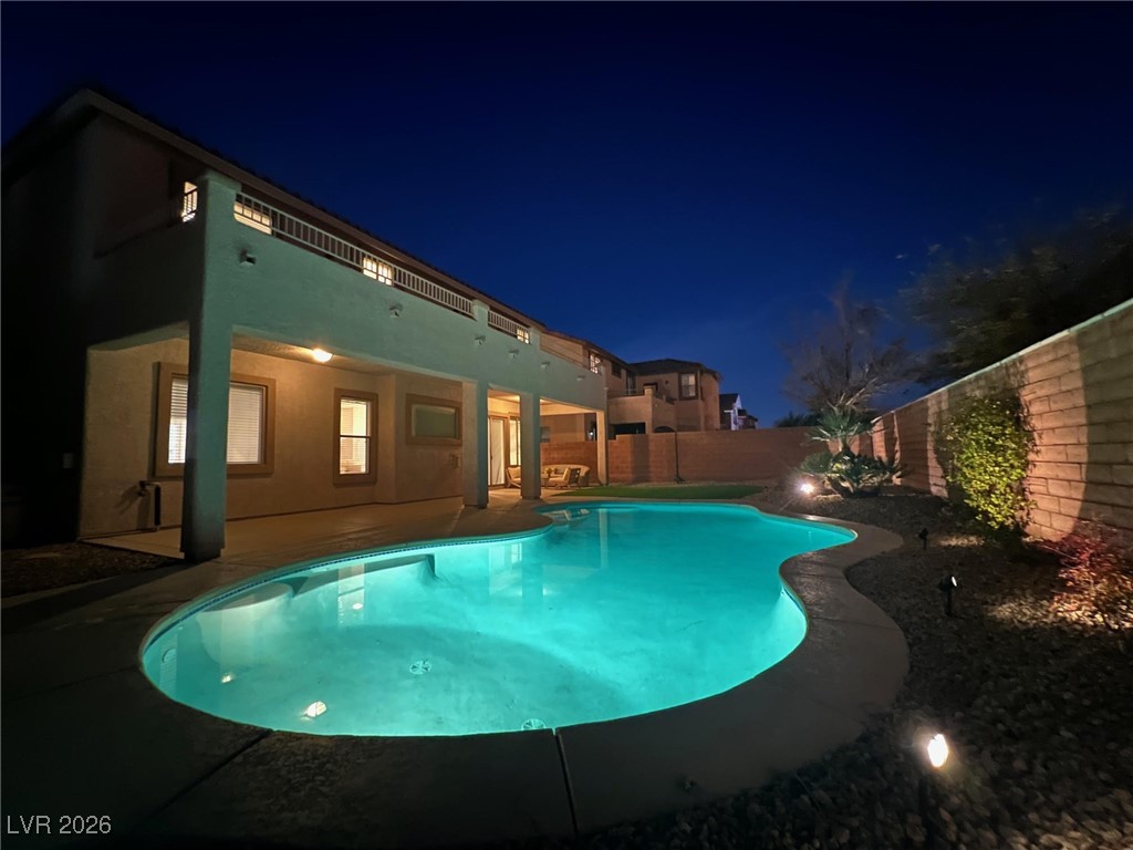 9632 Staff Lane Las Vegas, NV 89178 - Photo 44 of 53 Pool at night featuring a patio and a fenced backyard
