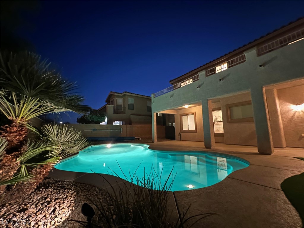 9632 Staff Lane Las Vegas, NV 89178 - Photo 45 of 53 Pool at night featuring a patio and a fenced backyard