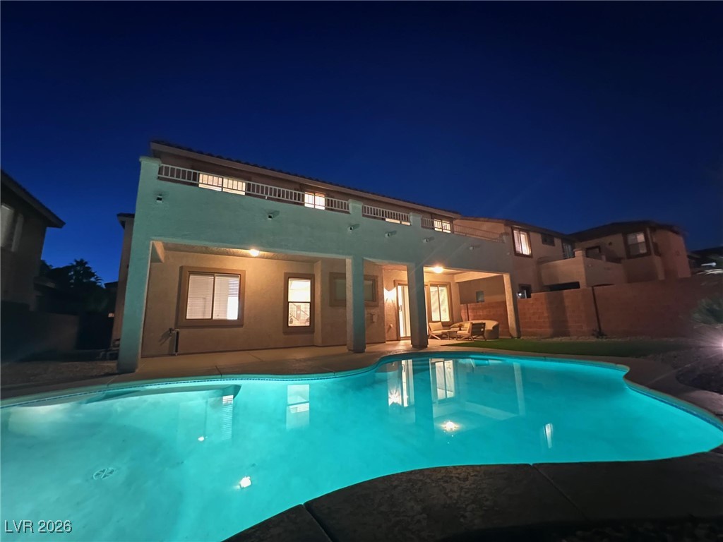 9632 Staff Lane Las Vegas, NV 89178 - Photo 47 of 53 Pool at night with a patio area
