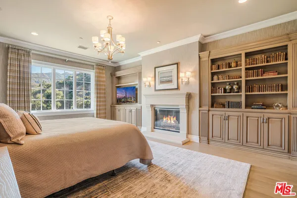 a spacious bedroom with a large bed and a fireplace