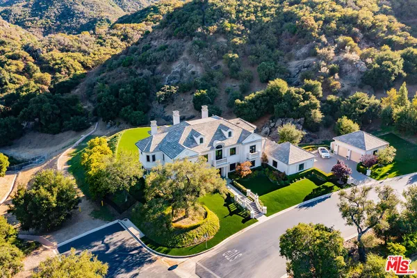 an aerial view of a house with a swimming pool yard and outdoor seating