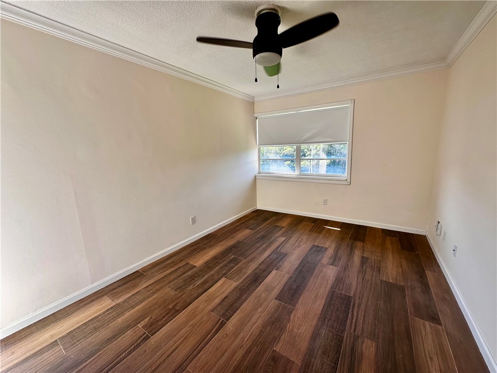 1815 Robalo Drive, Unit C201 Vero Beach, FL 32960 - Photo 16 of 31 an empty room with wooden floor and windows