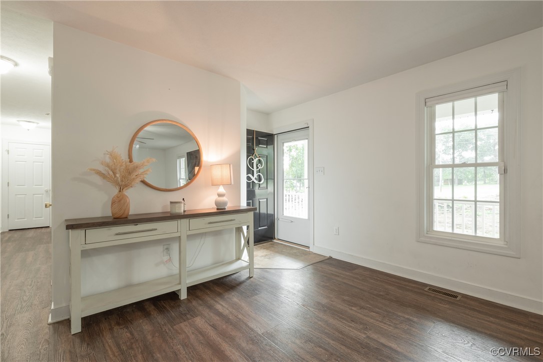 1315 Mill Road Aylett, VA 23086 - Photo 13 of 33 an empty room with wooden floor windows and a wooden floor