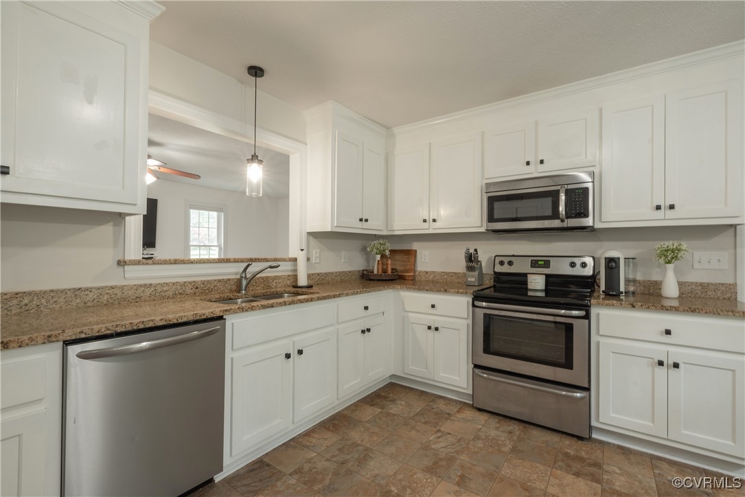1315 Mill Road Aylett, VA 23086 - Photo 23 of 33 a kitchen with granite countertop white cabinets and stainless steel appliances