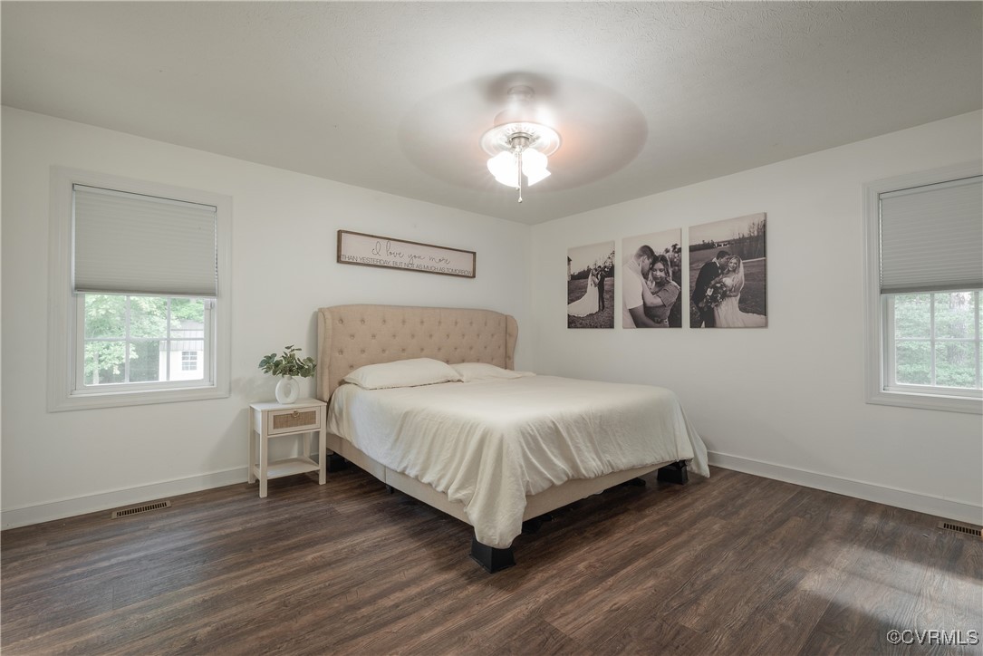 1315 Mill Road Aylett, VA 23086 - Photo 30 of 33 a bedroom with a large bed chandelier and a window