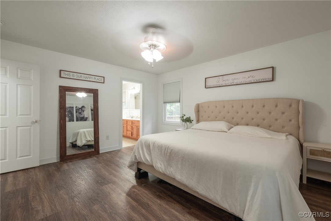 1315 Mill Road Aylett, VA 23086 - Photo 31 of 33 a bedroom with a large bed and a chandelier