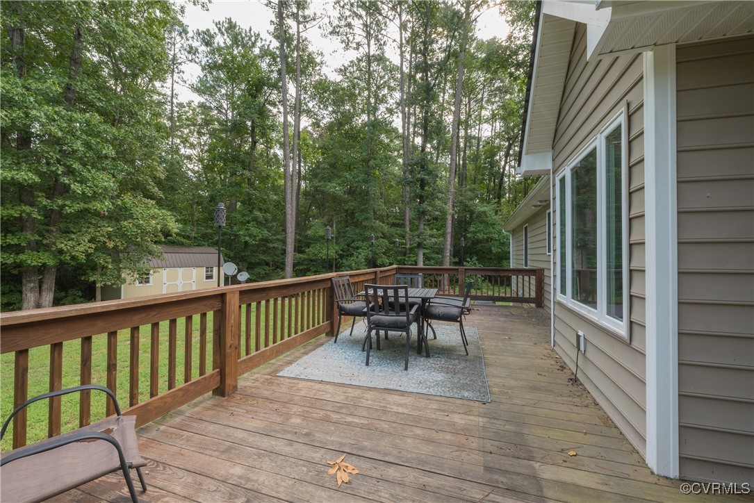 1315 Mill Road Aylett, VA 23086 - Photo 10 of 33 a view of a roof deck with table and chairs and wooden floor