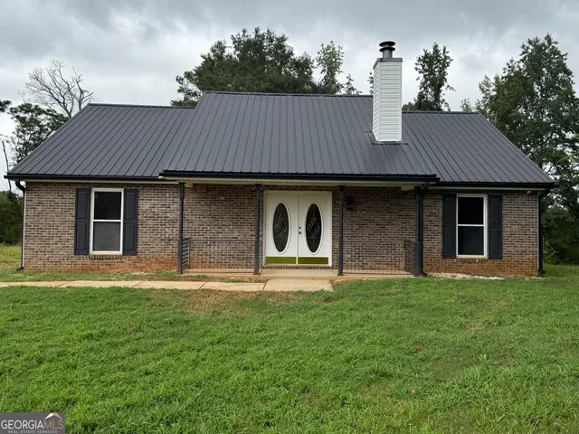 a front view of house with a garden