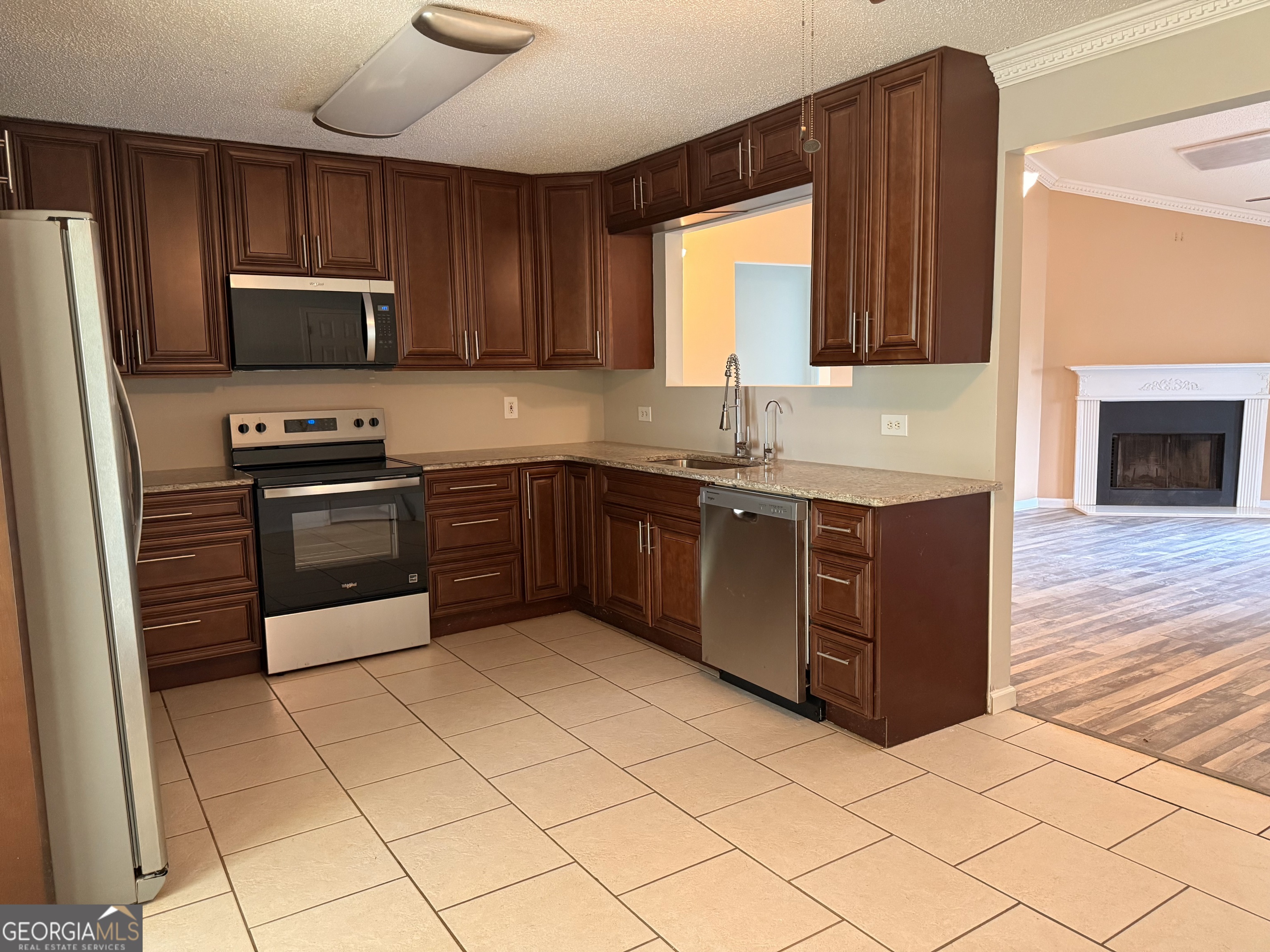 323 Snapping Shoals Road McDonough, GA 30252 - Photo 8 of 20 a kitchen with stainless steel appliances granite countertop a stove a sink dishwasher and a refrigerator
