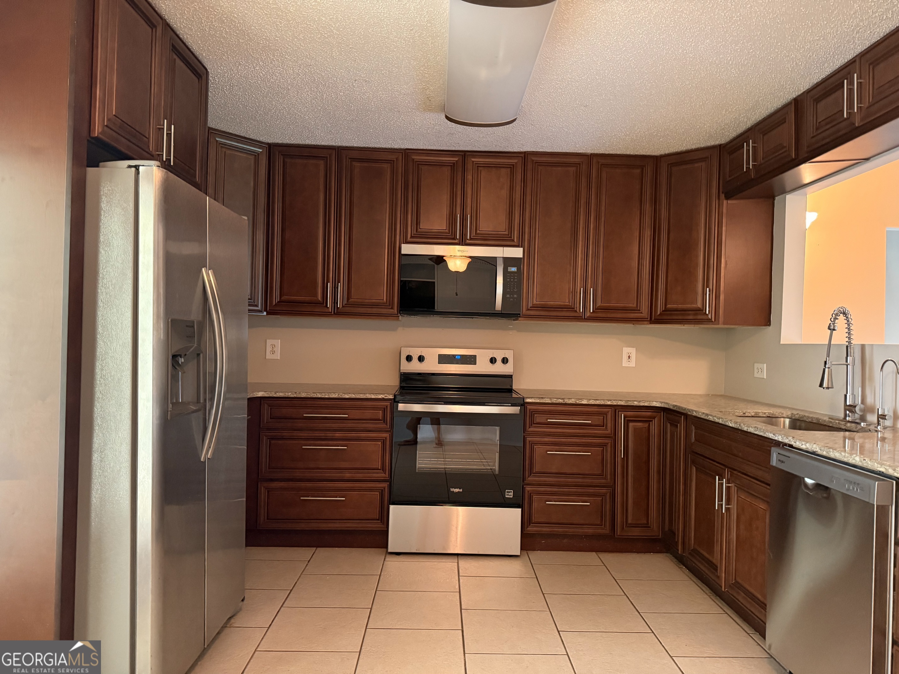 323 Snapping Shoals Road McDonough, GA 30252 - Photo 9 of 20 a kitchen with stainless steel appliances granite countertop a refrigerator and a sink