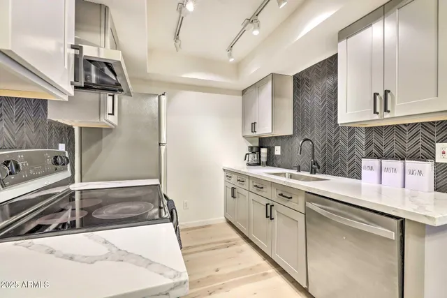 a kitchen with a sink refrigerator and microwave