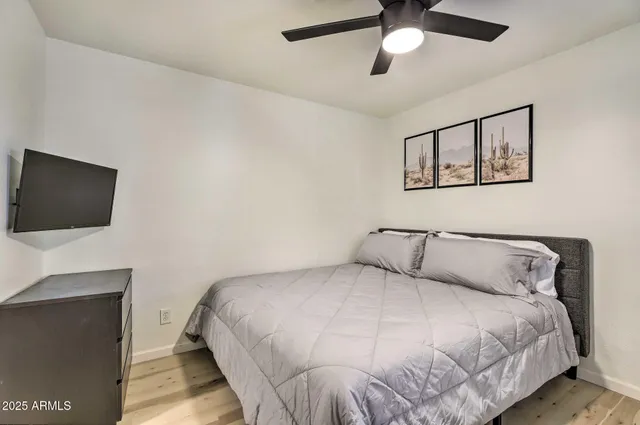 a bedroom with a bed and a flat screen tv