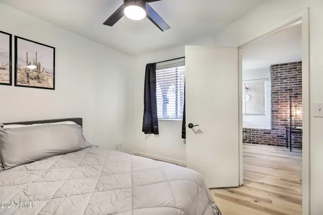 a bedroom with a bed and a window